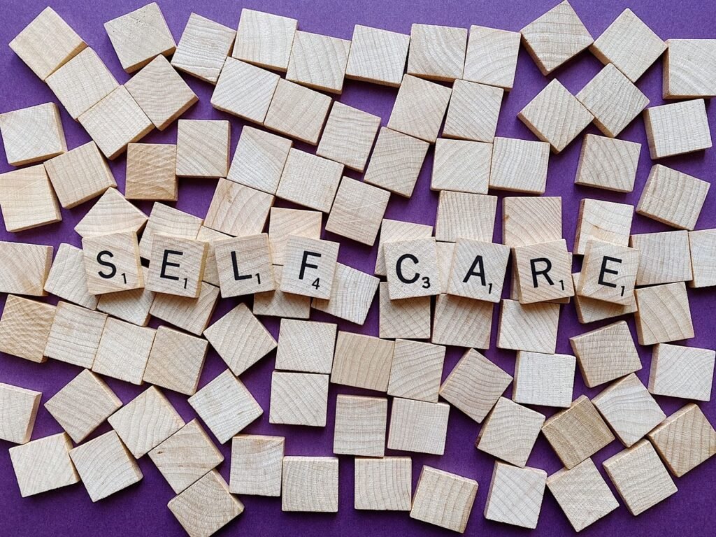 Letter tiles spell "self care."