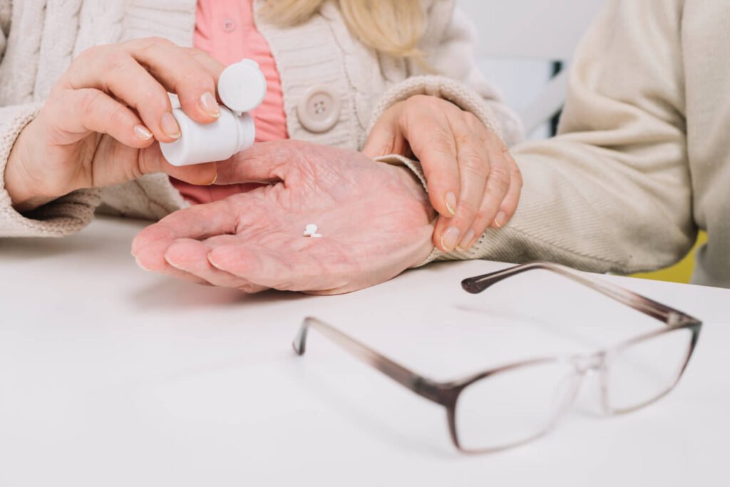 Caregiver dispensing medications.