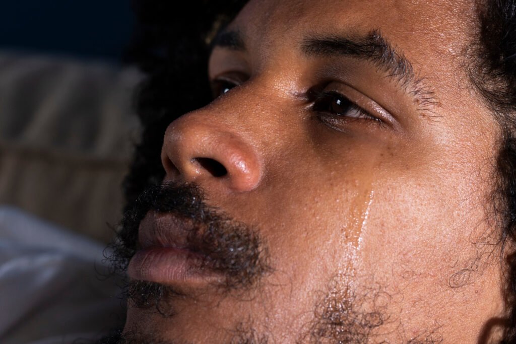 Depressed male caregiver cries
