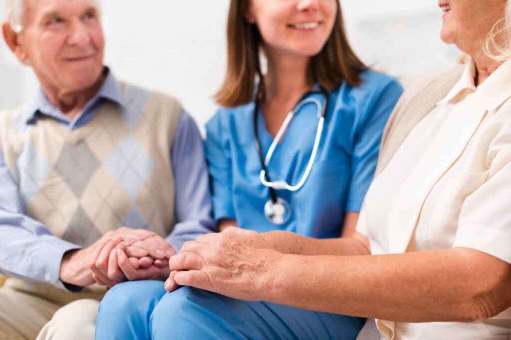 Nurse holds hands with family