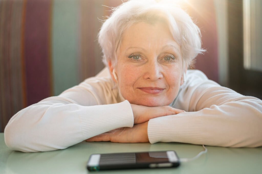 senior-woman-looking-at-camera-with-smartphone