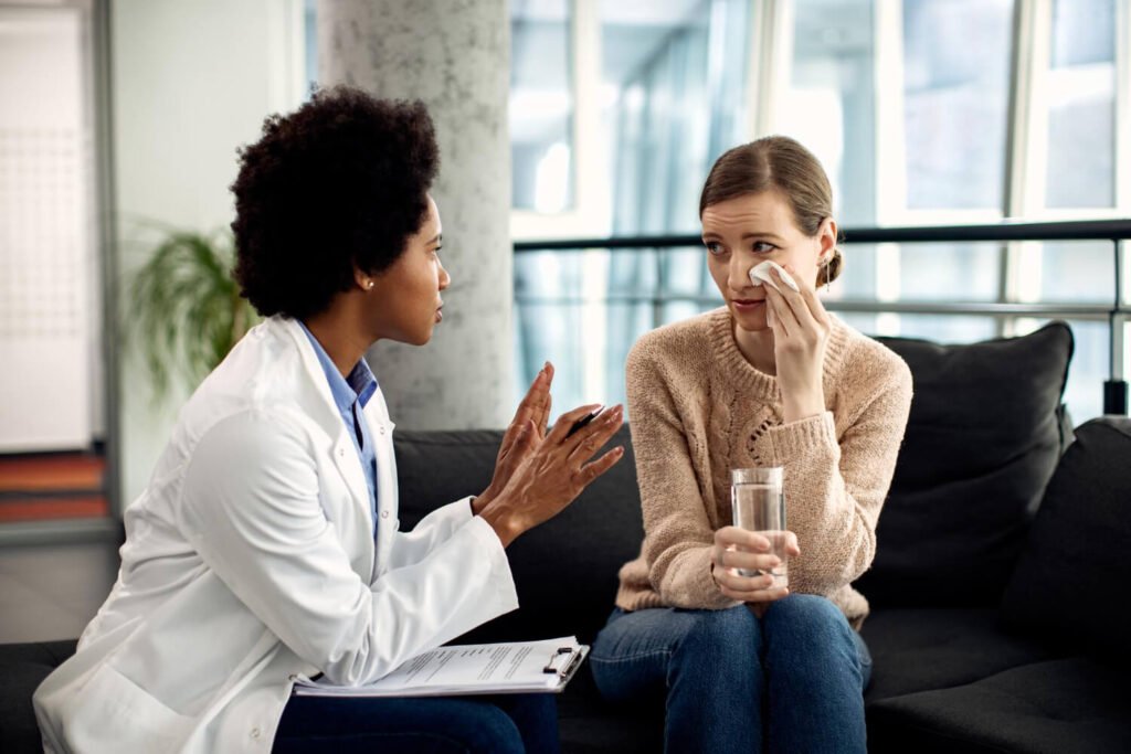 Young and stressed family caregiver talks to doctor