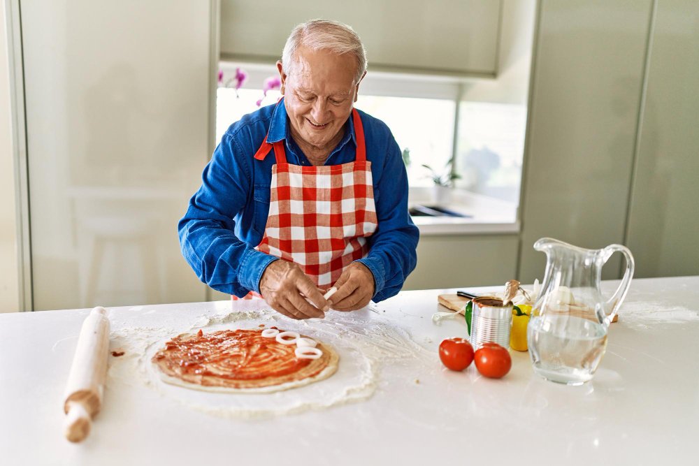Male caregiver makes pizza
