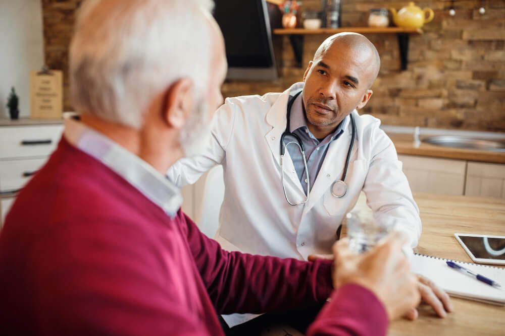Doctor speaks to male caregiver.