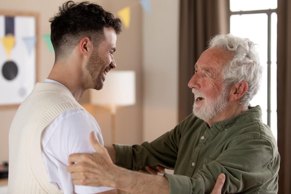 Male caregiver greets senior man