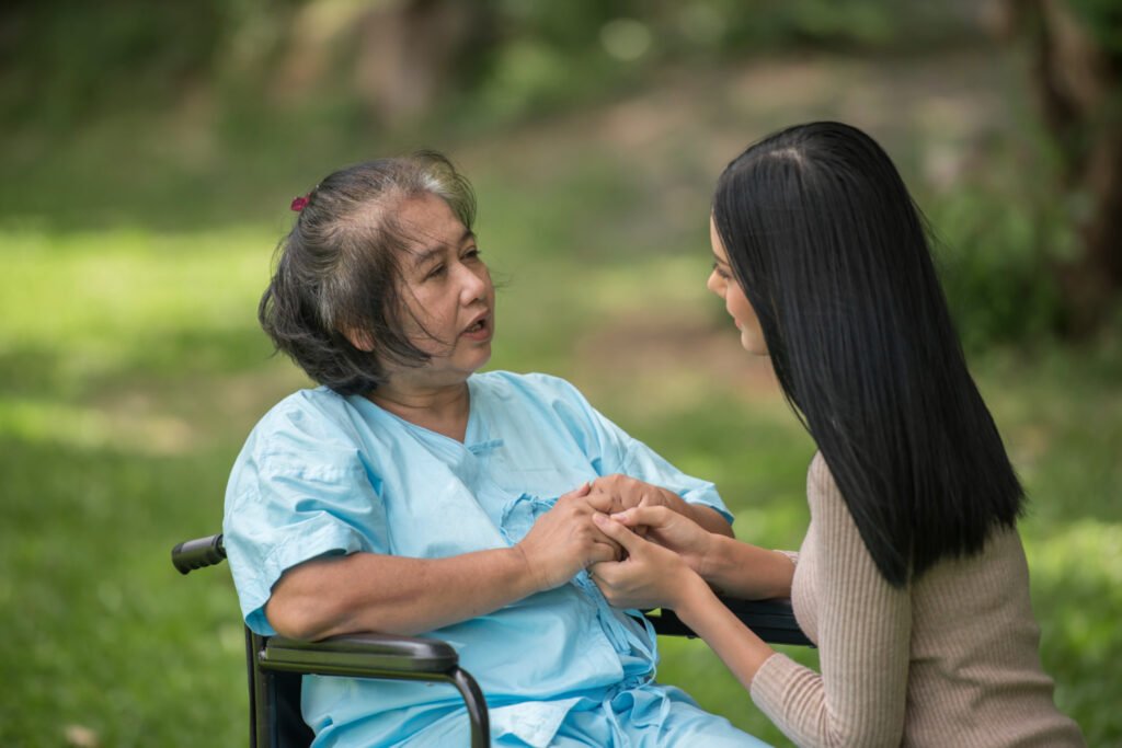 Family caregiver talks with loved one in wheelchair