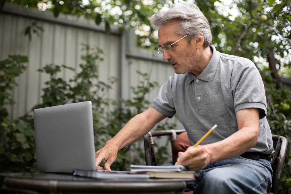 Senior male caregiver plans vacation.