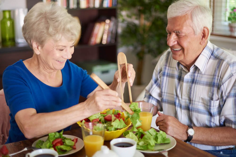 Elderly couple enjoys a nutritious meal together.