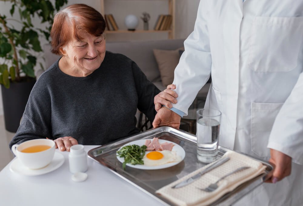 Nursing home patient gets a meal.
