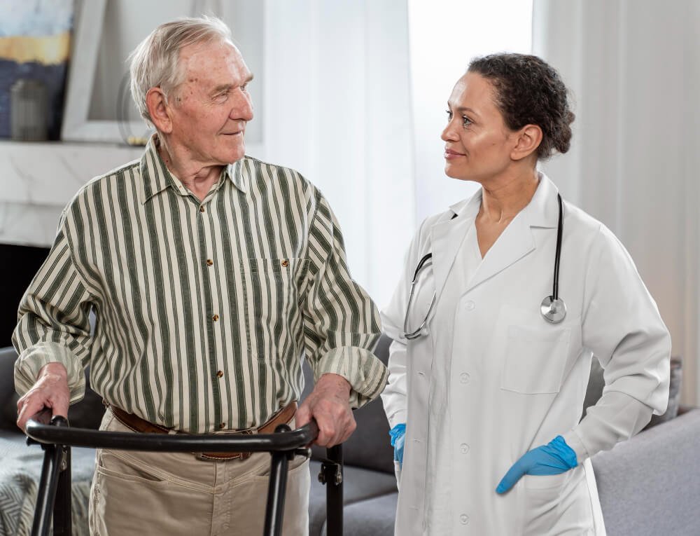 Nursing home doctor speaks to elderly patient on walker.