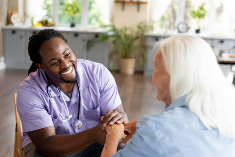 Nursing home caregiver cares for elder female.