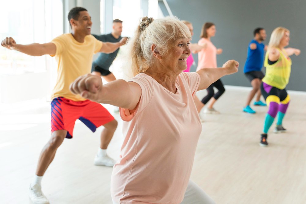 Senior female caregiver enjoys group exercise