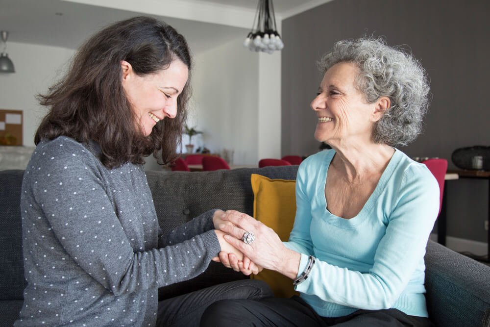 Woman visits with elderly parent
