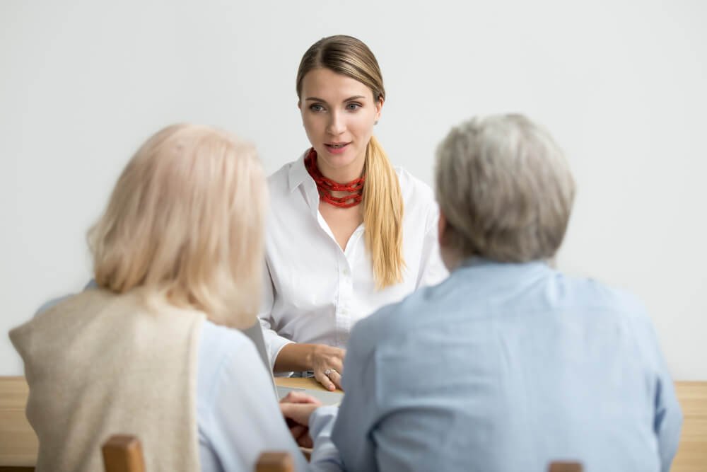 Nursing home administrator meets with a senior couple