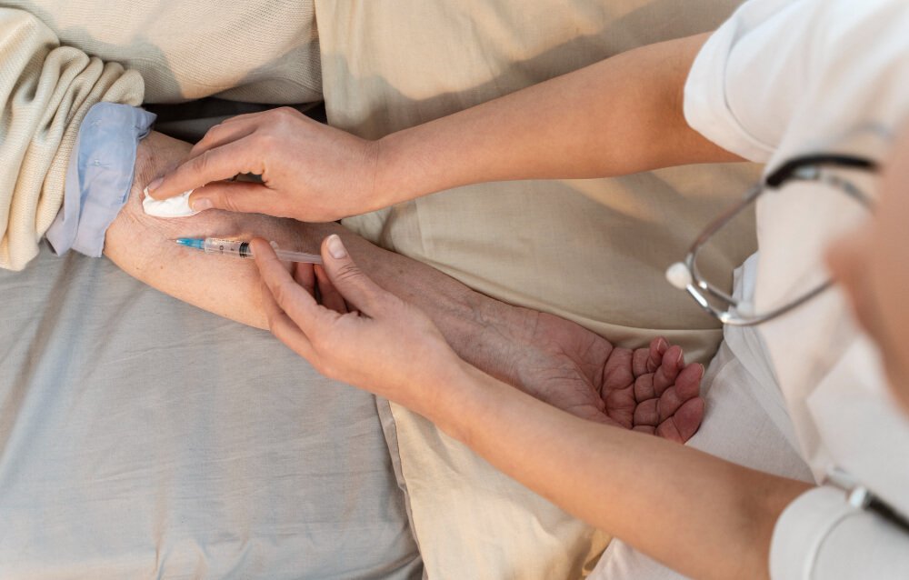 Doctor injects pain drug into arm of elderly patient.