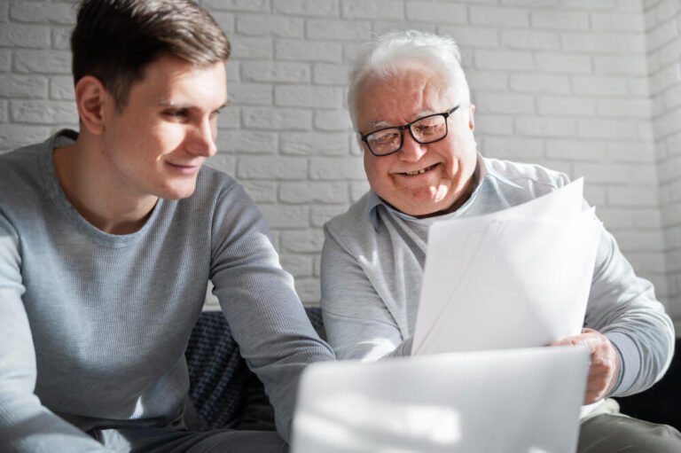 Young man reviews emergency plan with his elderly grandfather.