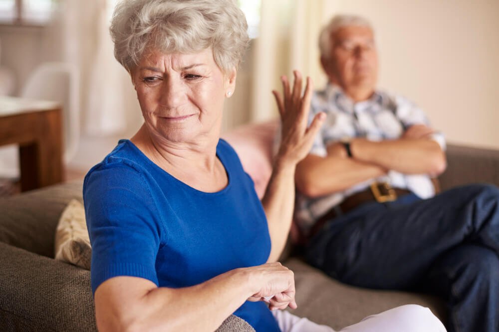 Resistant woman turns away and holds up her hand.