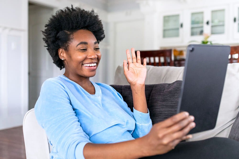 Young female caregiver on video call