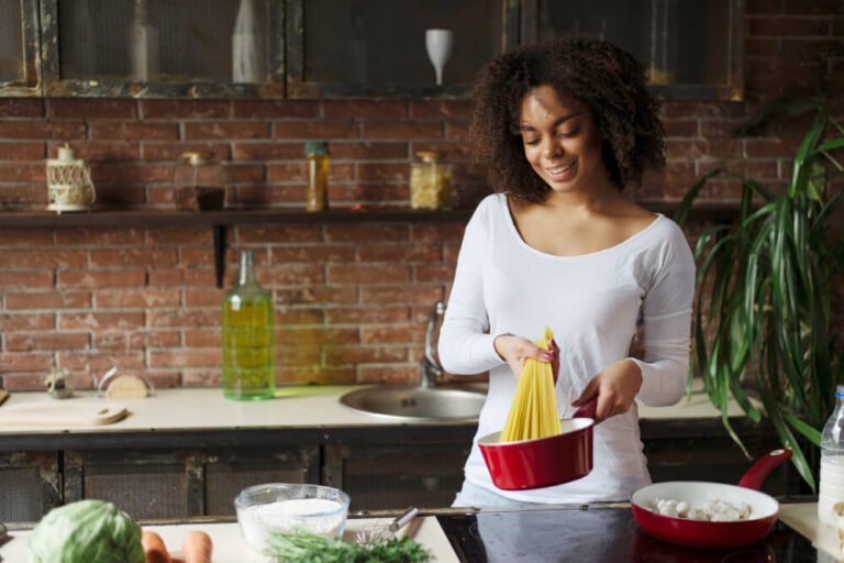 Female caregiver preparing spaghetti