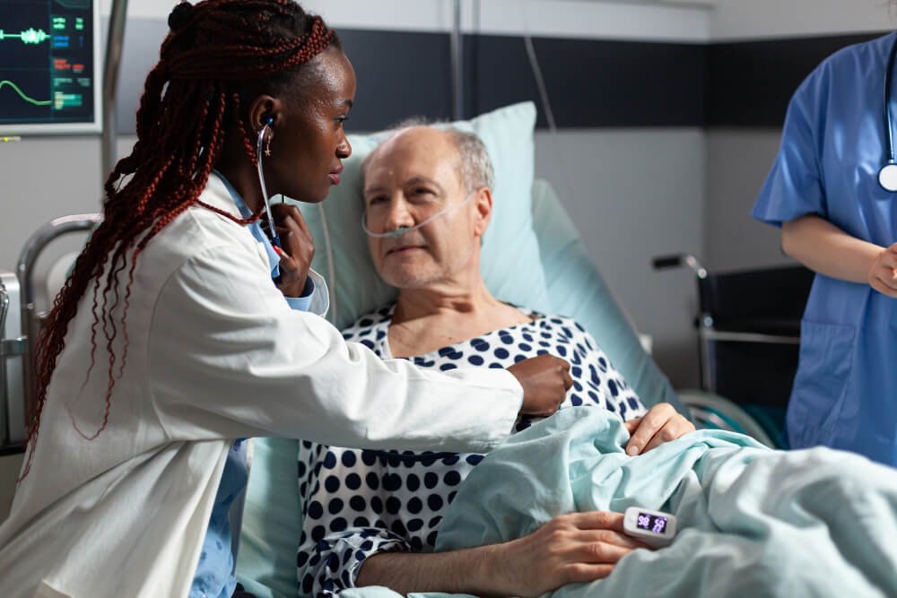 Female doctor checks senior man's heart