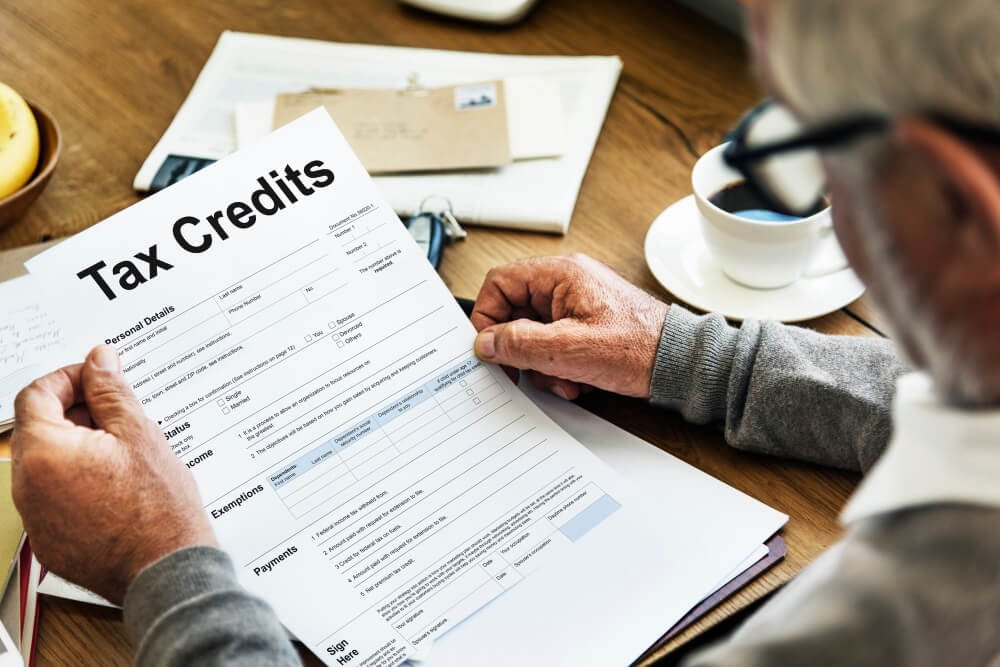 senior man completes tax credit form