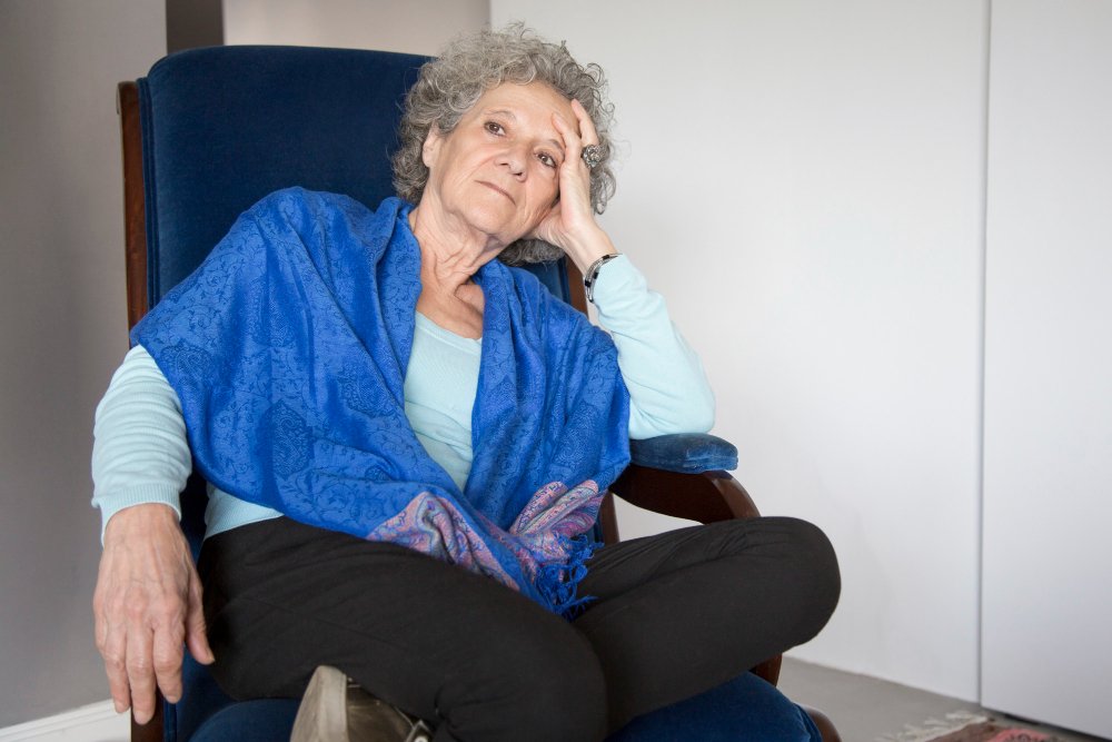 tired senior woman seated in chair