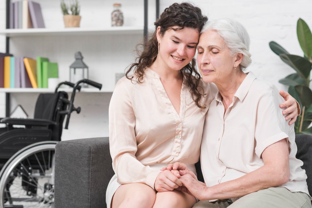 adult daughter hugs her grandmother
