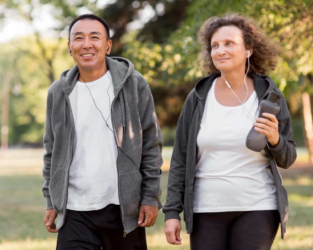 couple walks outdoors in athletic attire