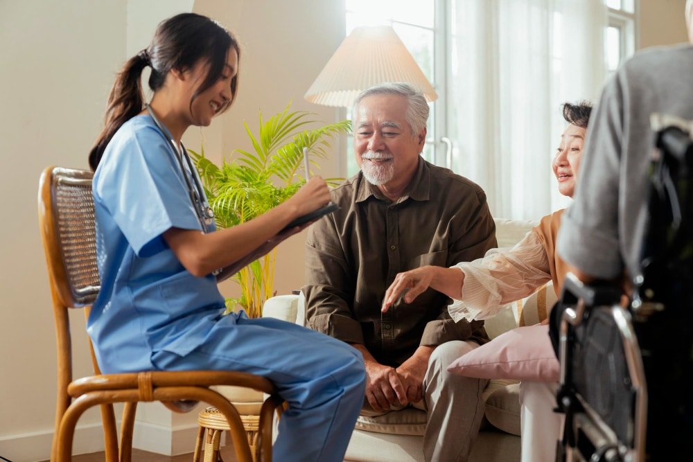 nurse talks to elderly adults at nursing home