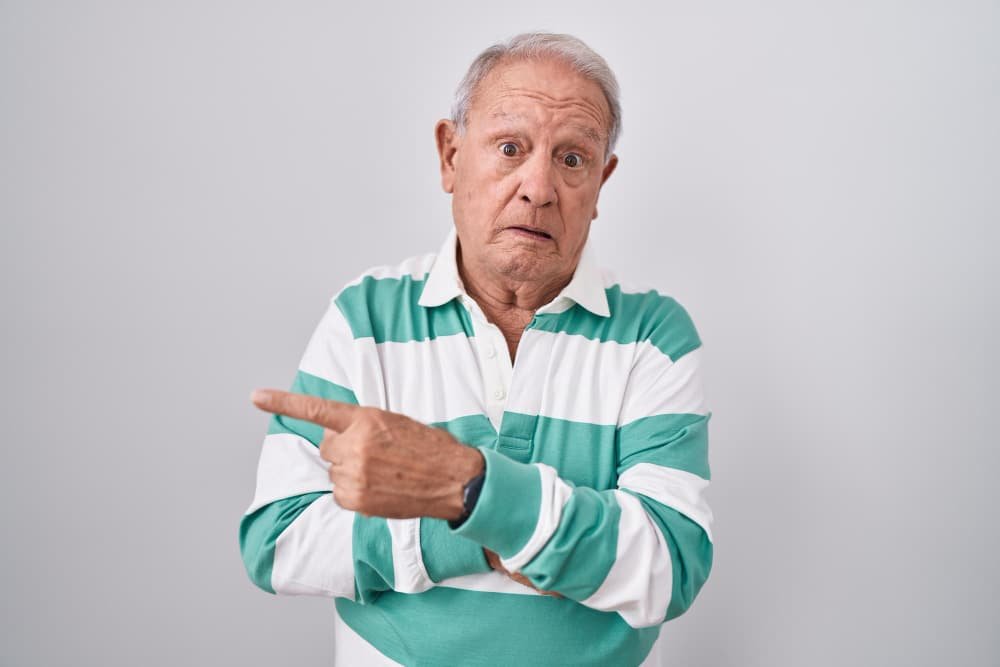 senior man points accusingly