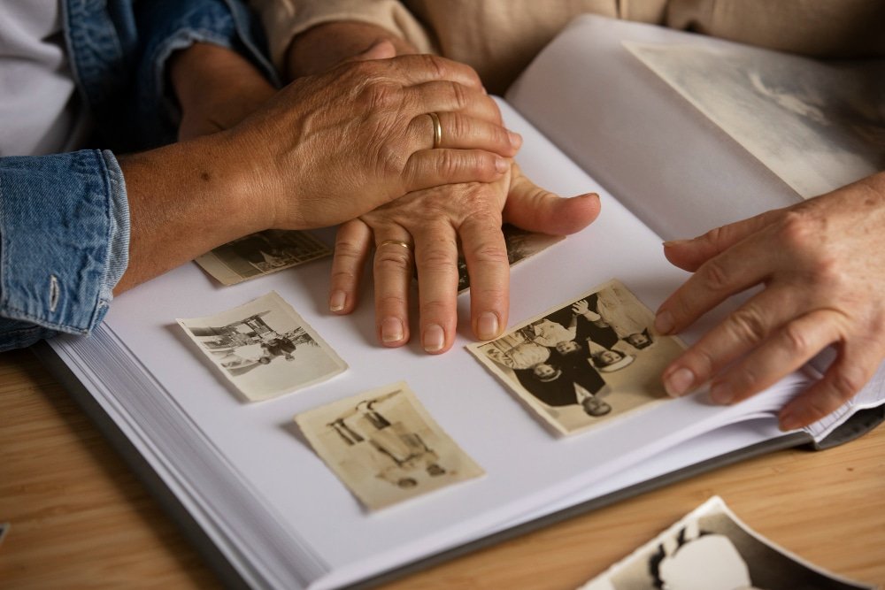 close-up of hands on photo album