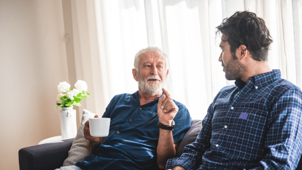 man talks with his elderly father
