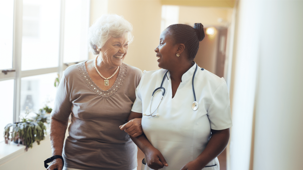 nurse walks and talks with elderly nursing home resident