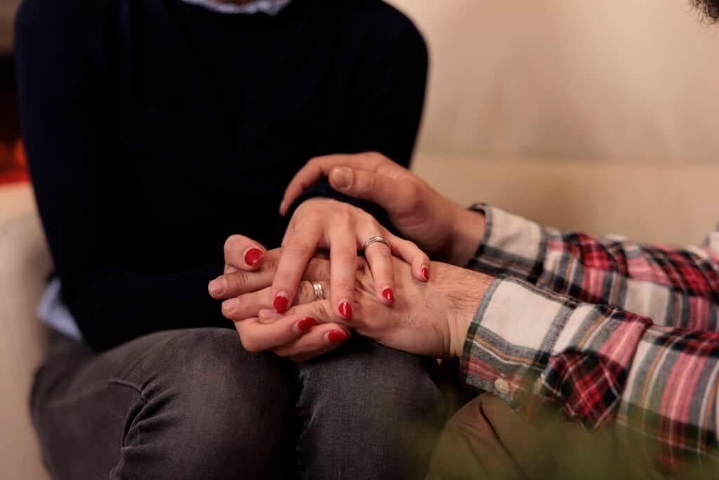 offering comfort through a touch of the hand