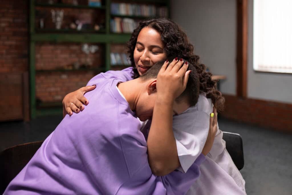 woman hugs man in support group
