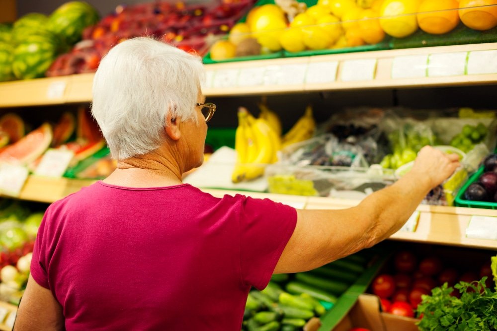senior woman shops for groceries in store
