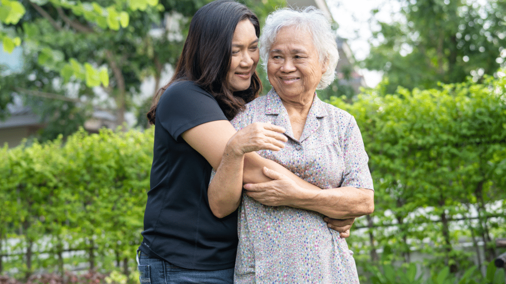 woman hugs and talks to her elderly mother
