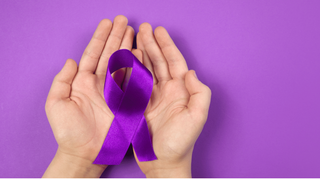 close-up of hands holding alzheimer's awareness ribbon