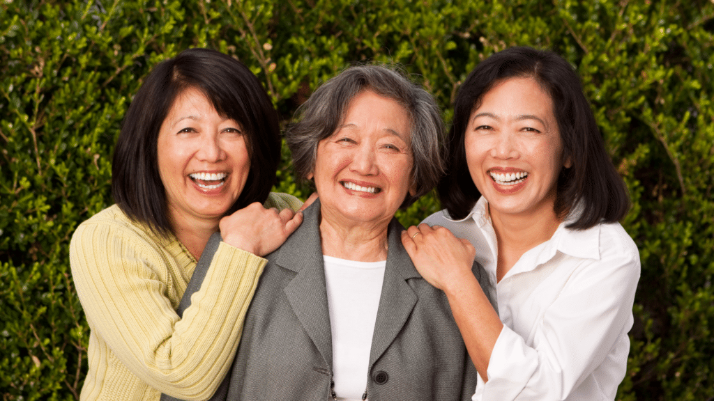 adult sibling caregivers pose with elderly mother